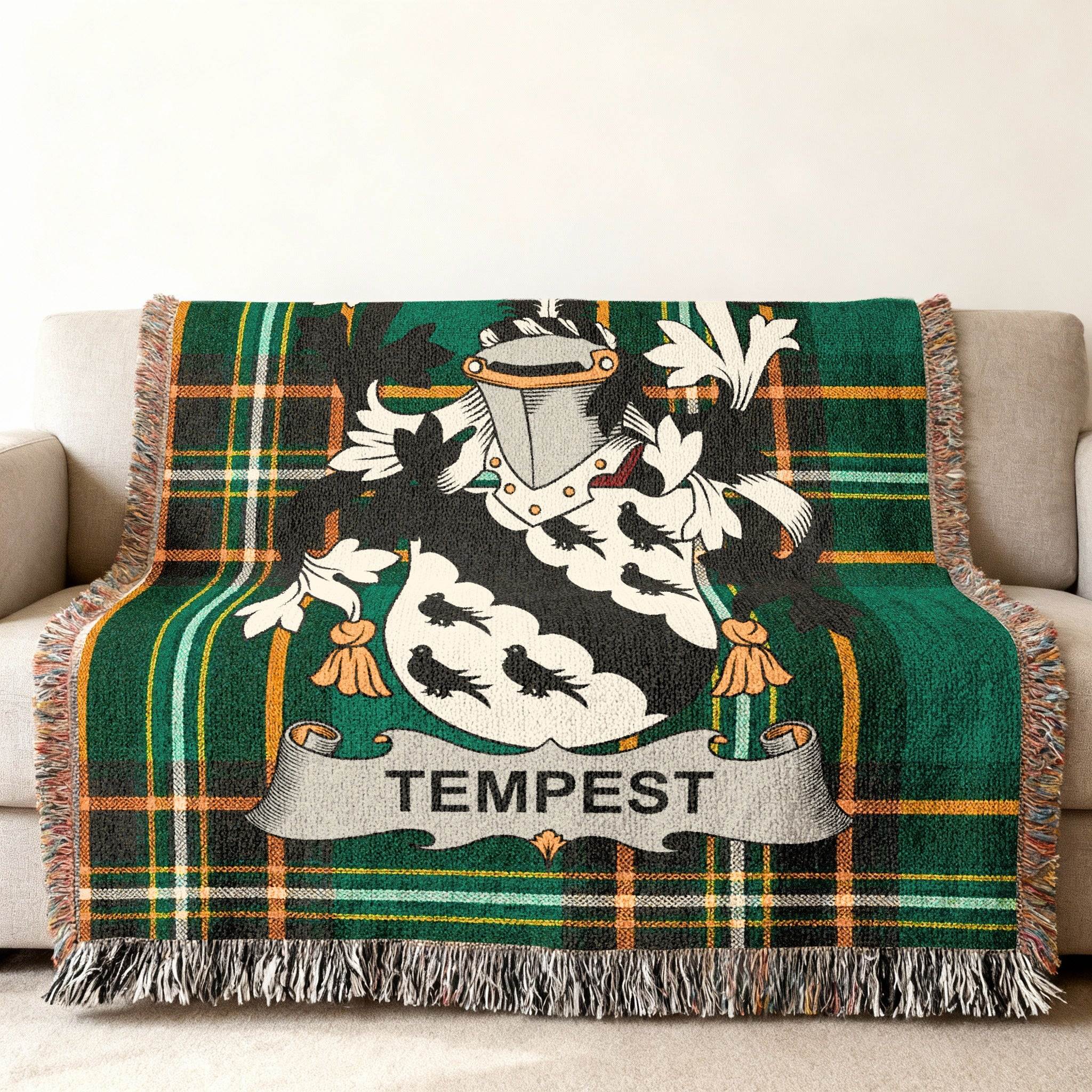 Green tartan throw blanket with white Tempest family crest.