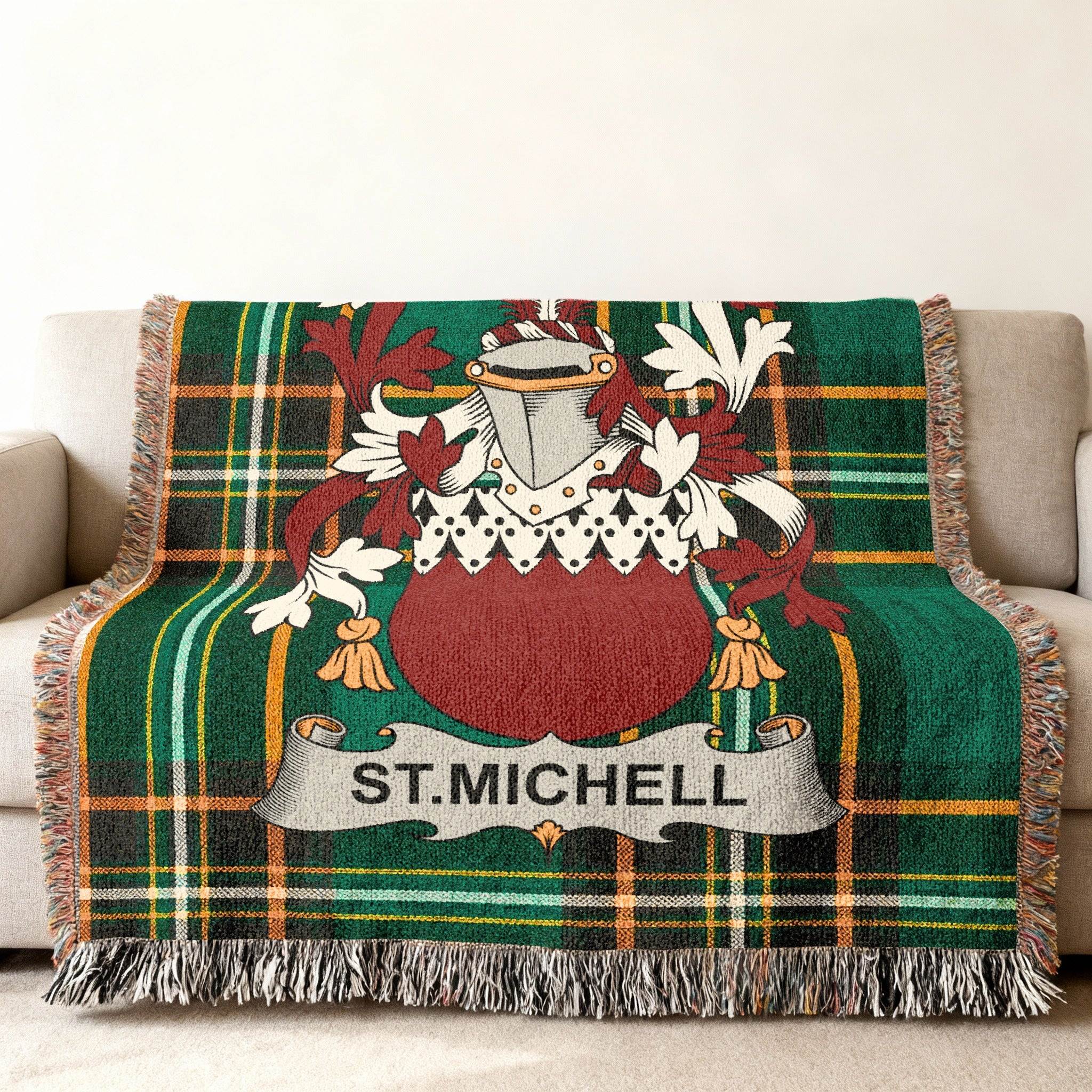 Green plaid throw blanket with St. Michell family crest on a couch.