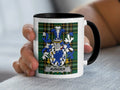 Mug with green tartan and a blue and white coat of arms with the name "AUNGIER".