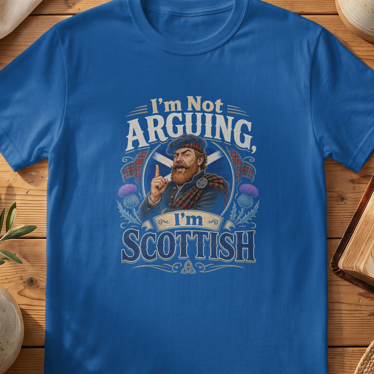Blue t-shirt with "I'm Not Arguing, I'm Scottish" and Scottish man graphic.