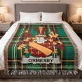 Tartan blanket with Ormsby crest displayed centrally over a bed.