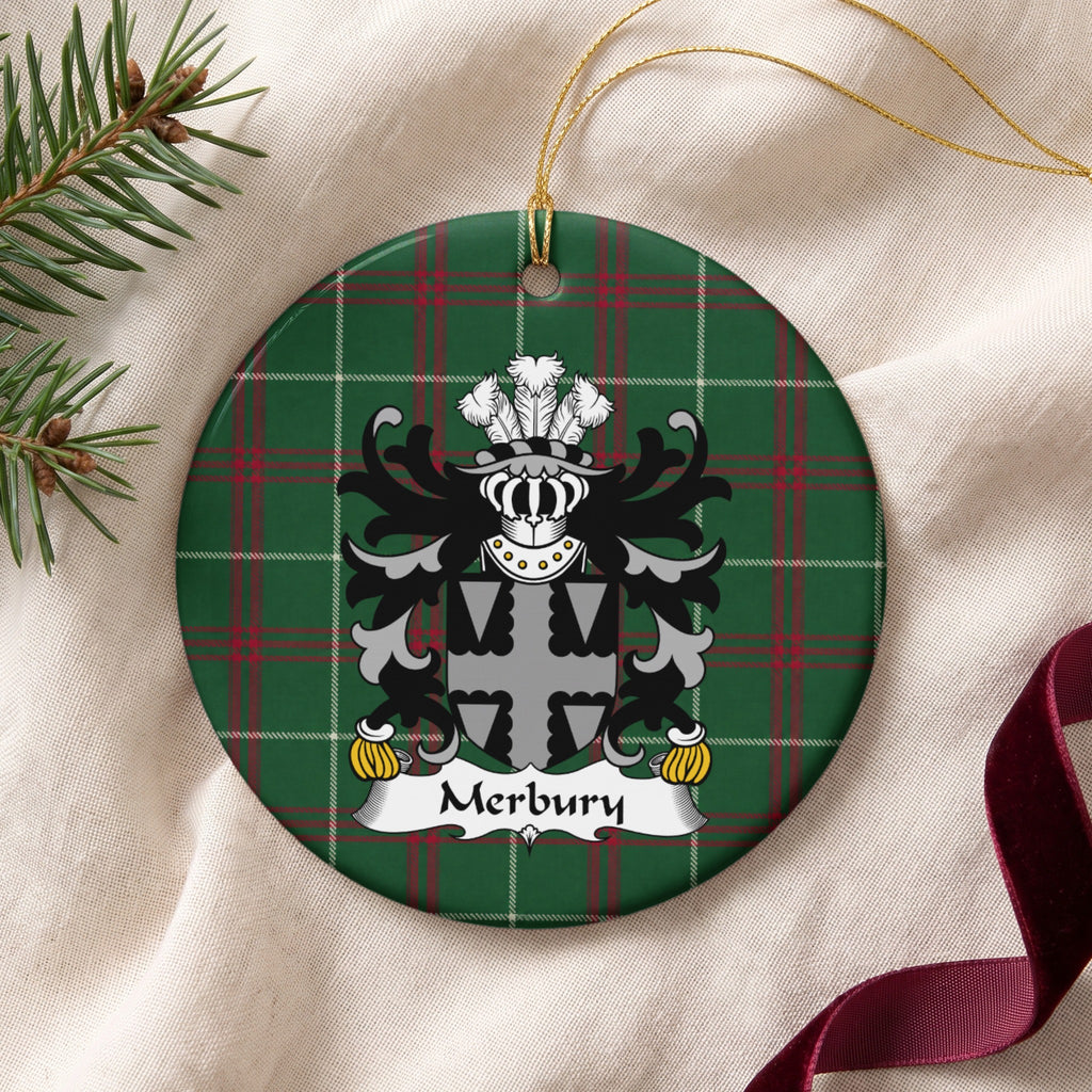 Merbury ornament on cream fabric with gold string, evergreen and burgundy ribbon; a gray-and-black shield with a scalloped cross pattern on Welsh National Tartan.