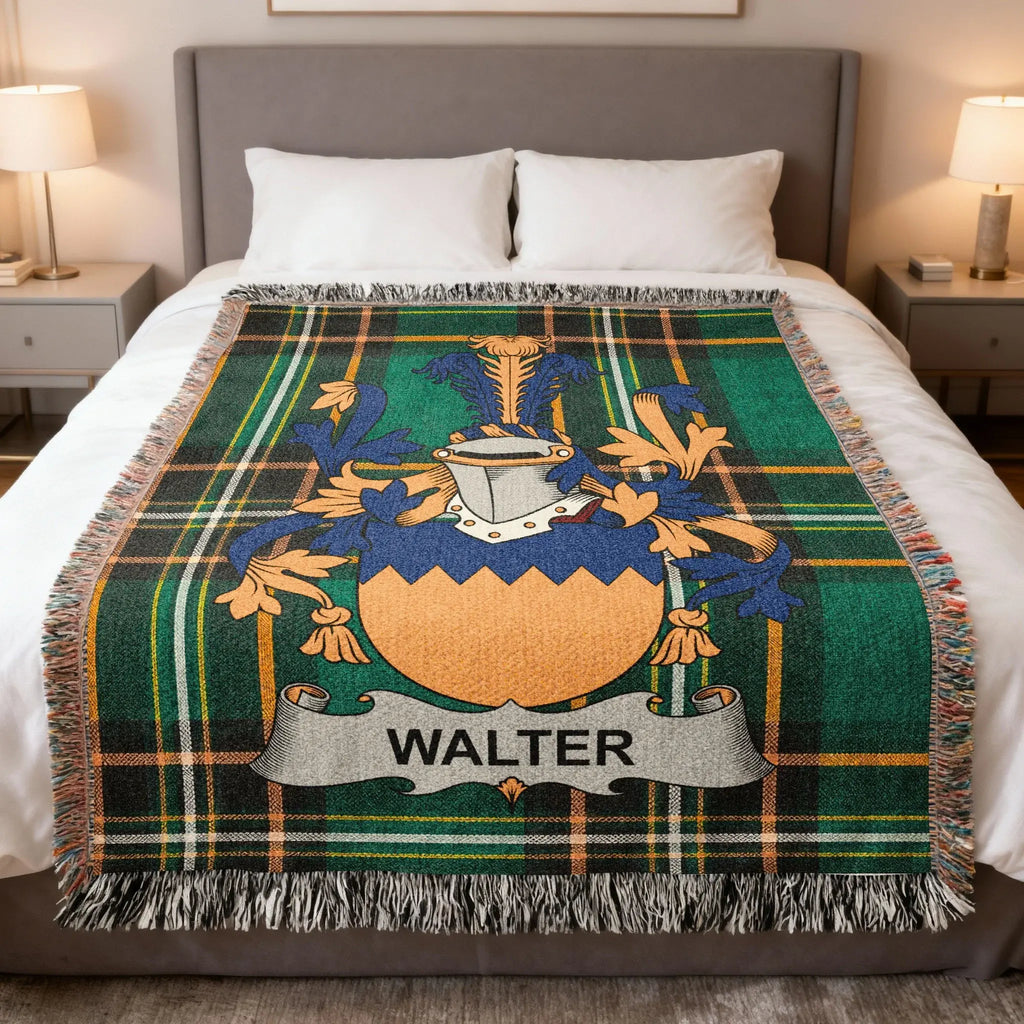 Plaid throw blanket with "WALTER" crest in blue, orange, and green on a bed.