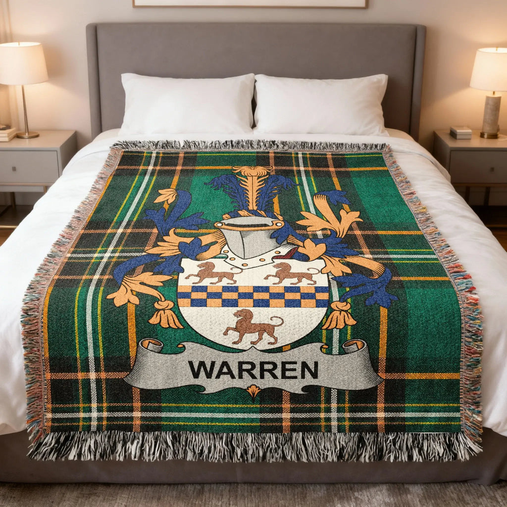 Tartan blanket with Warren family crest on a bed.