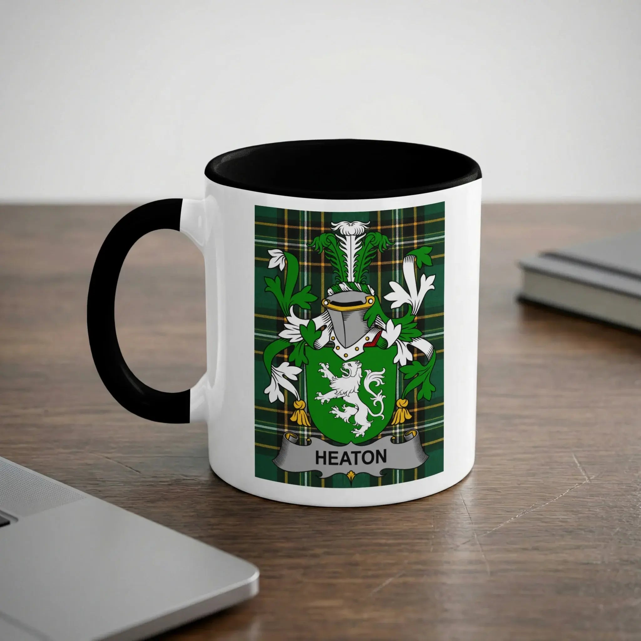 White mug with black rim featuring the Heaton family crest and name.