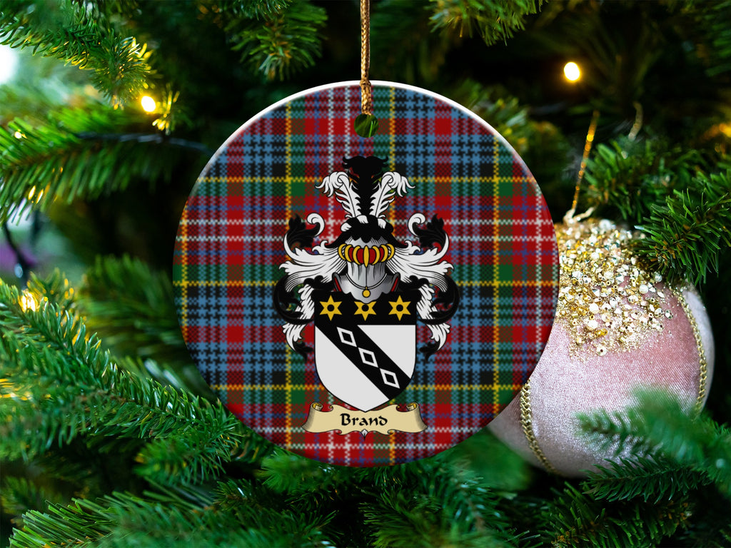 Brand Scottish clan ceramic ornament with family crest on a Caledonia tartan background, hanging on a Christmas tree