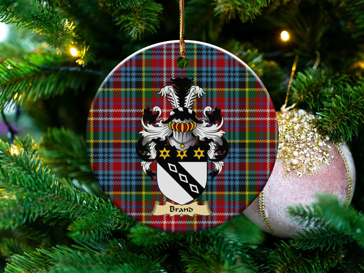 Brand Scottish clan ceramic ornament with family crest on a Caledonia tartan background, hanging on a Christmas tree
