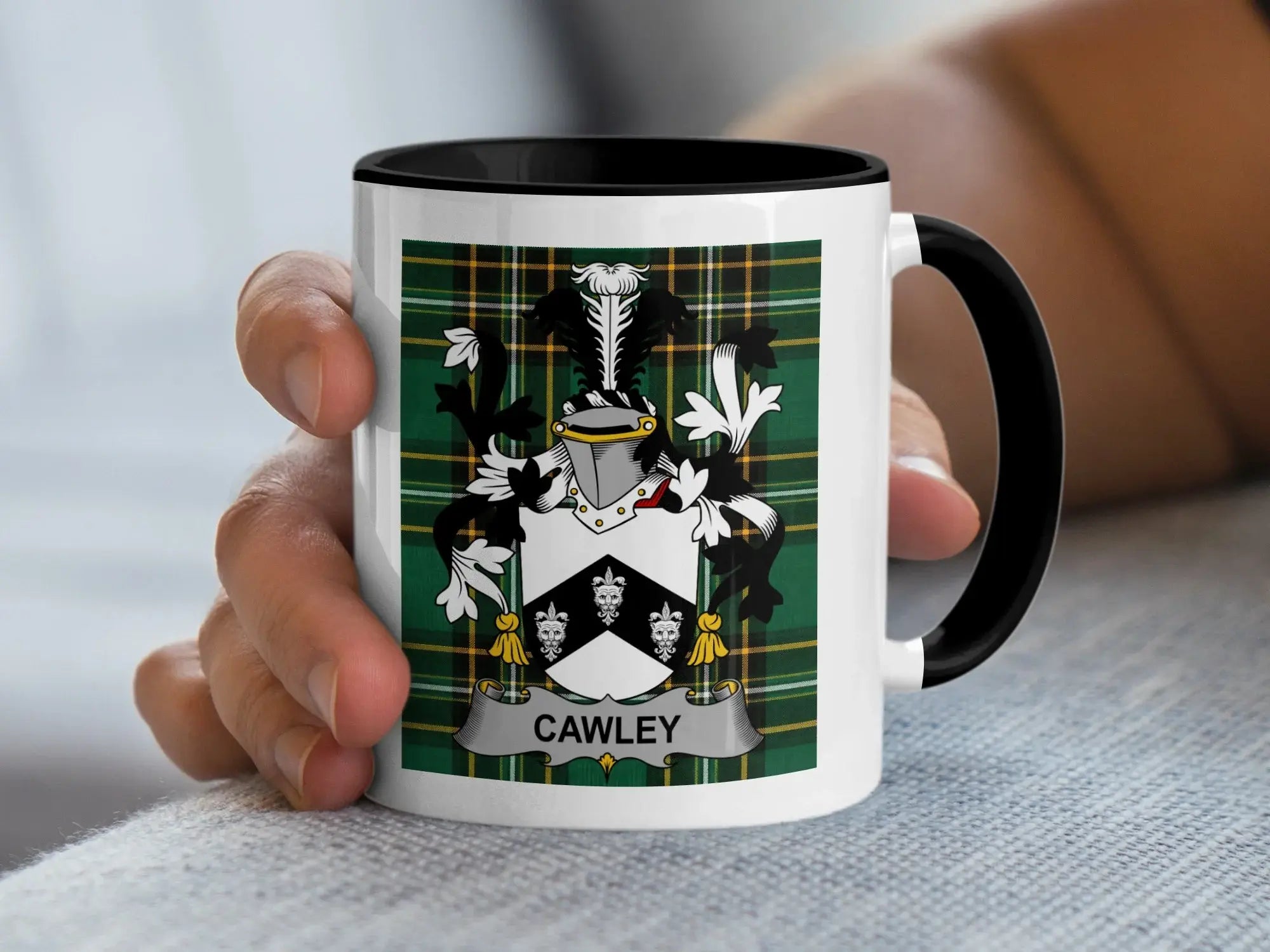 White mug with black rim featuring the Cawley family crest on a green plaid background.