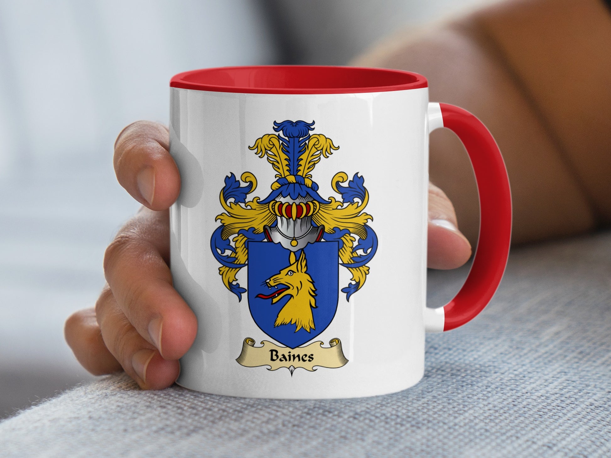 White mug with red handle displaying Baines family crest with yellow dog.