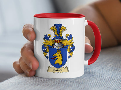 White mug with red handle displaying Baines family crest with yellow dog.