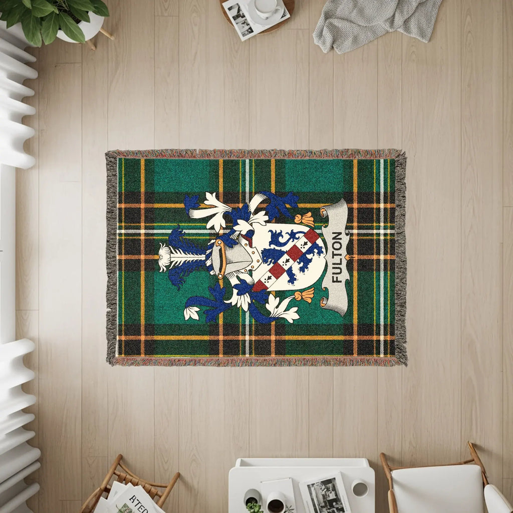 Fulton tartan throw blanket with family crest in center.