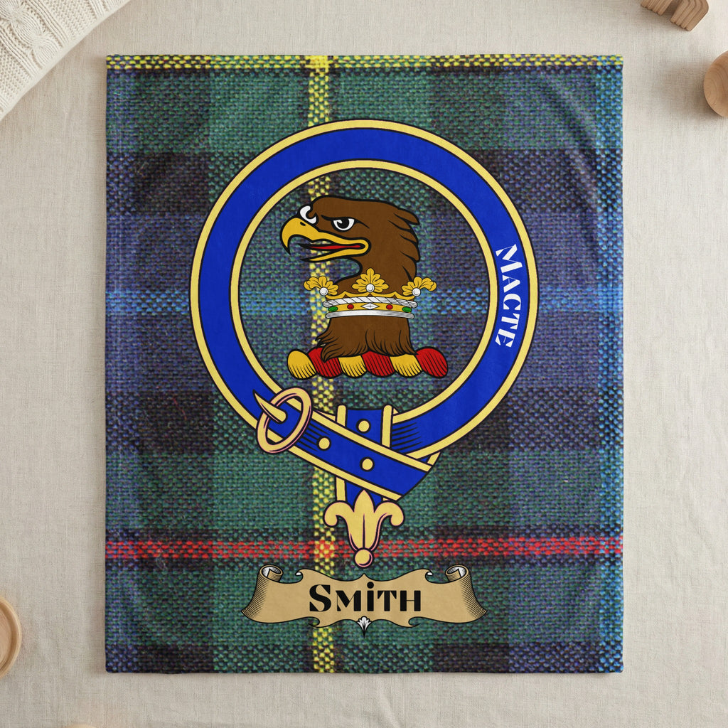 Smith Macte crest on green and blue tartan throw — draped display