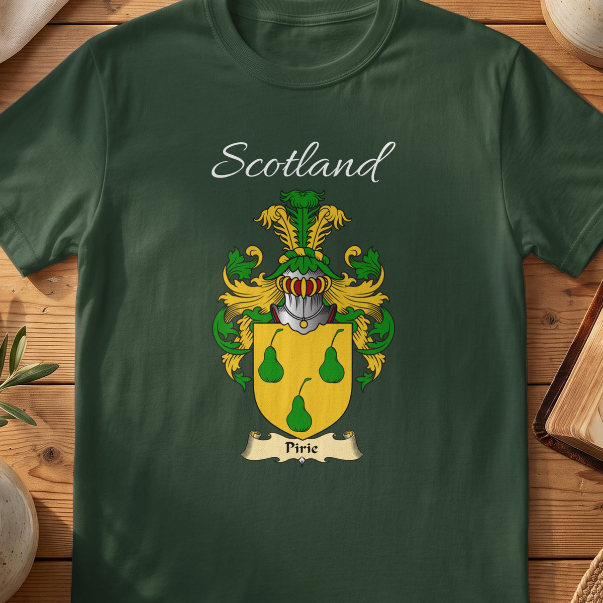 Forest Green Pirie Scottish T-shirt laid flat with coat of arms artwork and “Scotland” text.