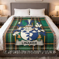 LINAKER family crest blanket on a bed with tartan pattern.