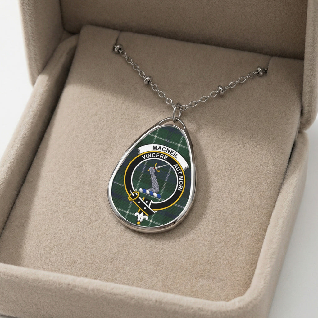Oval pendant necklace featuring MacNeil clan tartan and motto in a jewelry box.