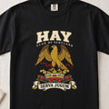 Hay graphic T-shirt in Black, front flat lay showing varsity lettering and gold eagle with spread wings and red ribbon.