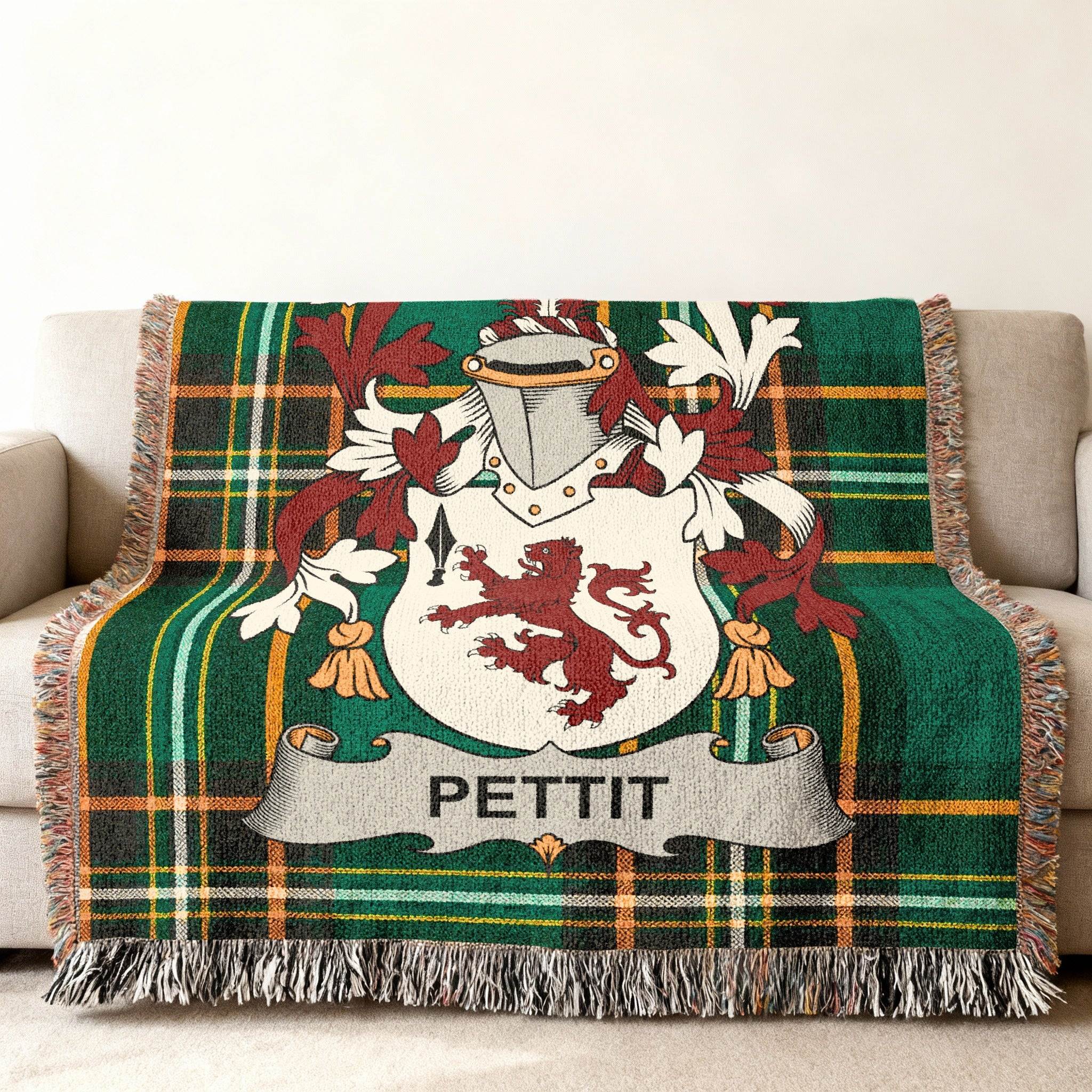 Green tartan throw blanket featuring the Pettit family crest with red lion.