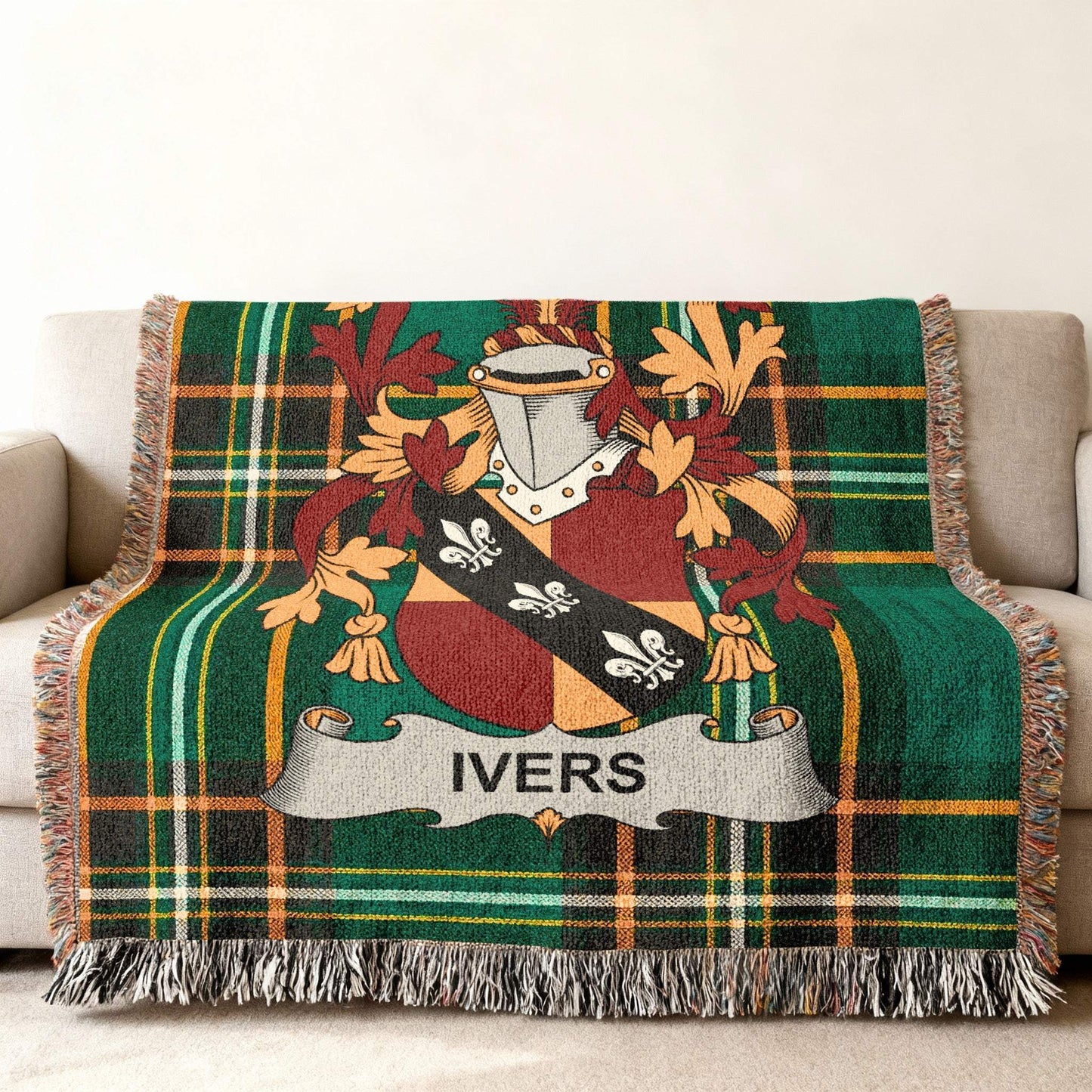 Tartan throw blanket featuring the Ivers family crest on a couch.