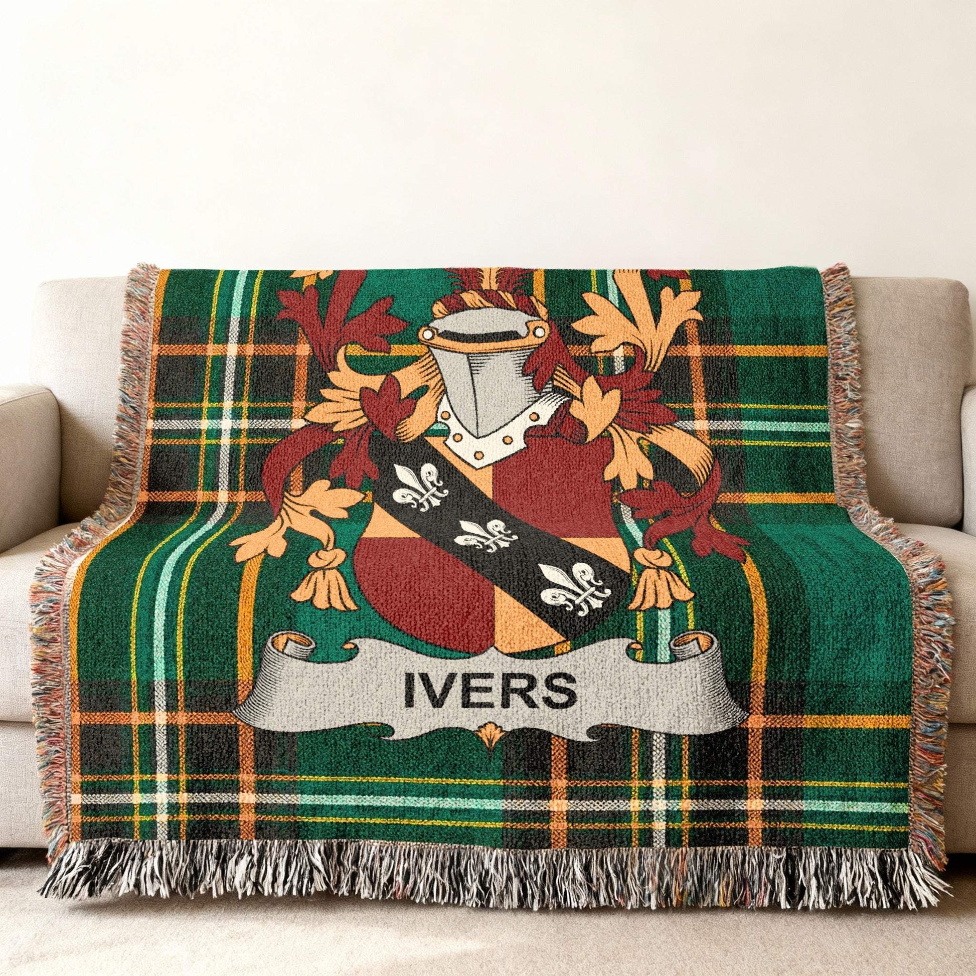Tartan throw blanket featuring the Ivers family crest on a couch.