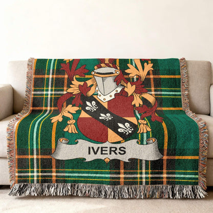 Tartan throw blanket featuring the Ivers family crest on a couch.