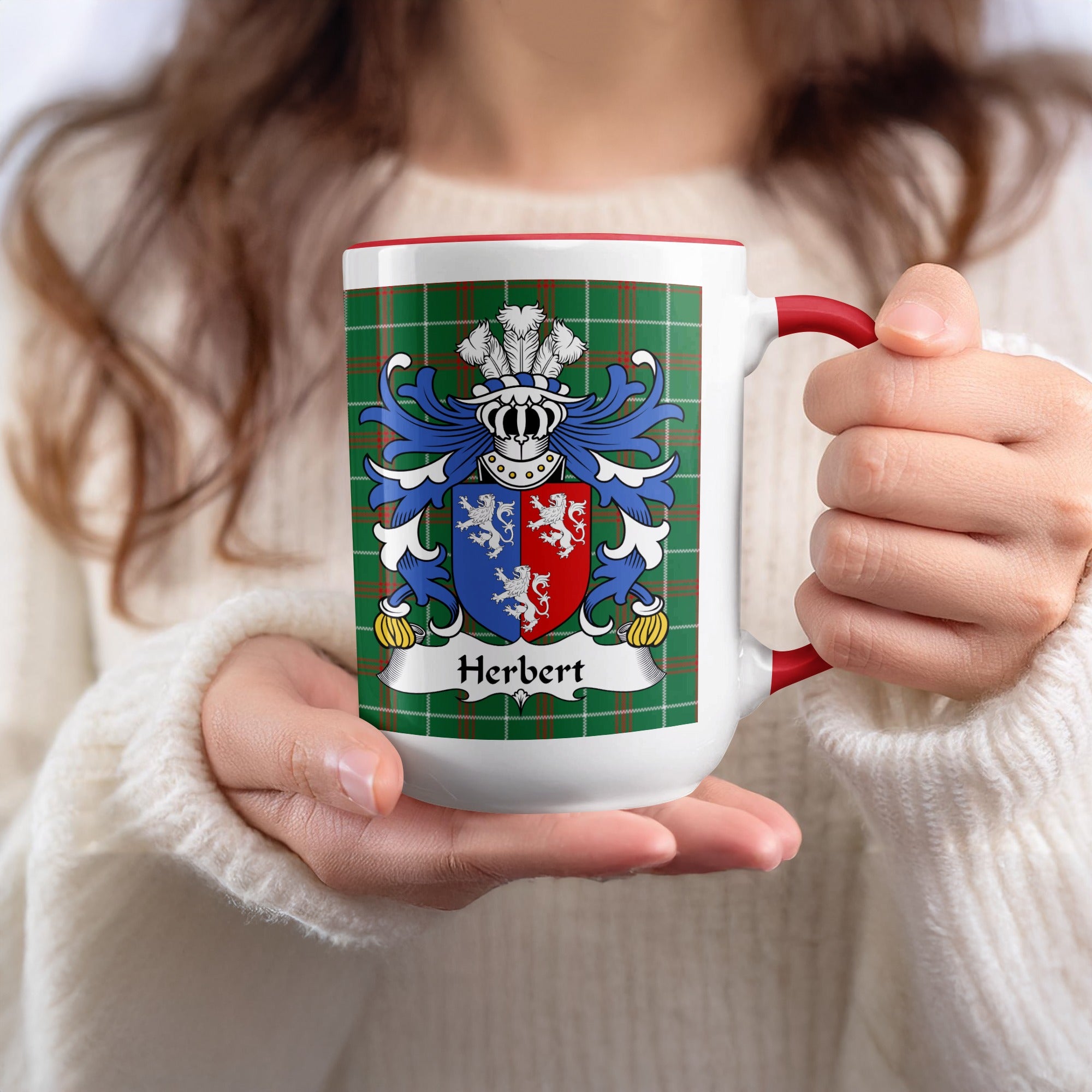 White mug with red trim featuring the Herbert family crest on a tartan background.