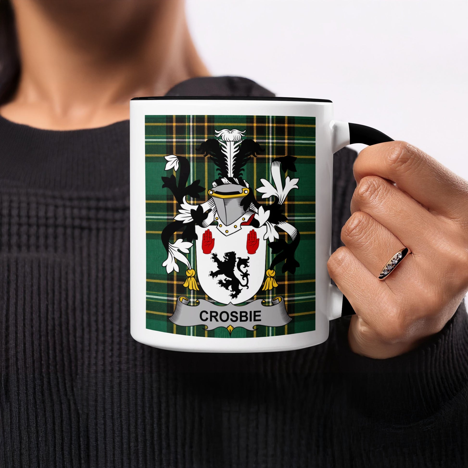 Crosbie family crest on a white mug with black handle and rim.