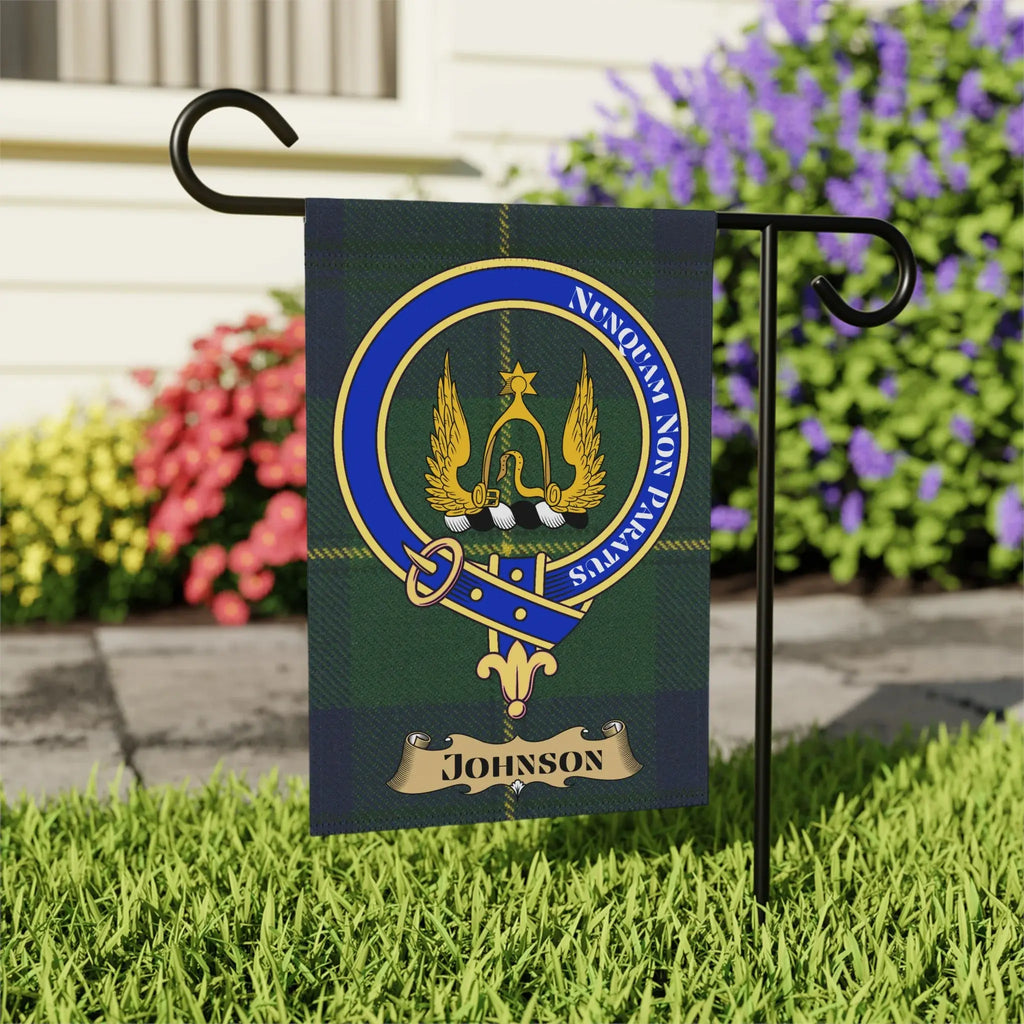 Johnson family tartan flag with crest and motto in a garden.