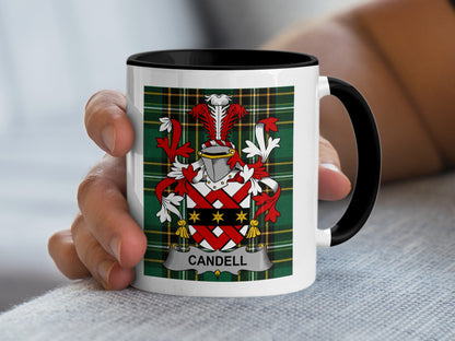 White mug with black rim showing the Candell family crest on tartan background.