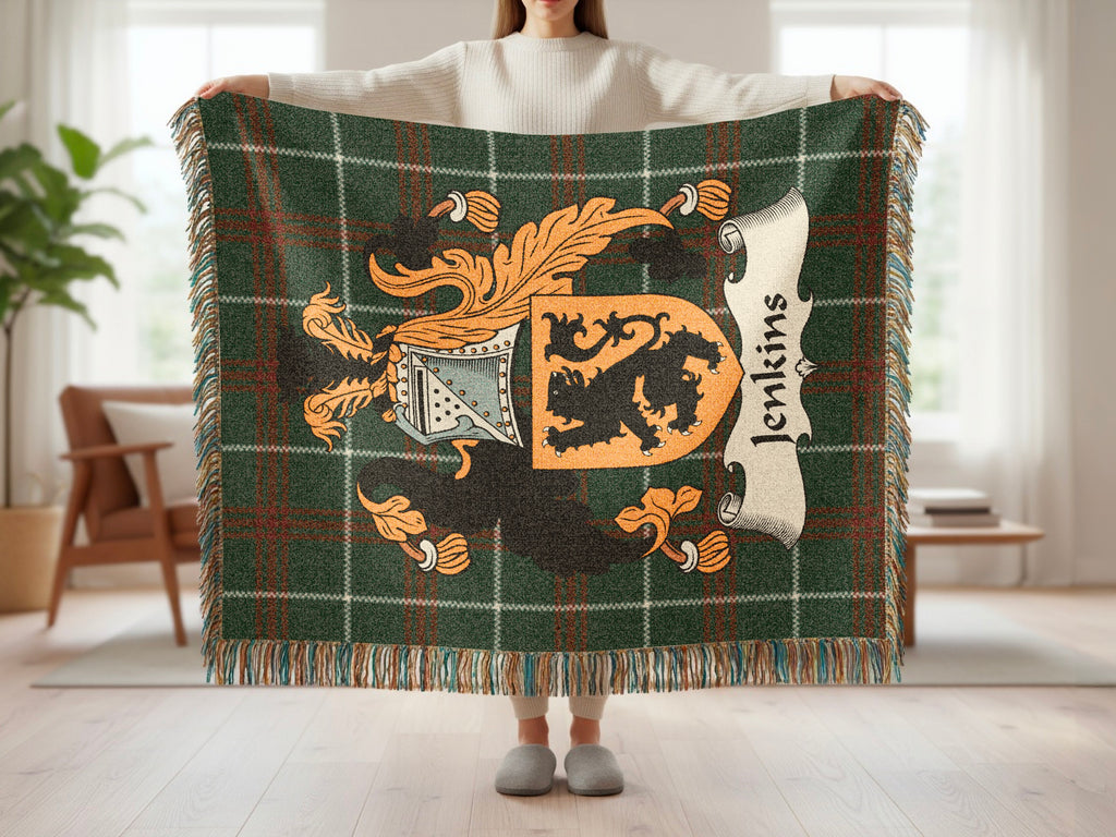 Green tartan blanket with Jenkins family crest held by a person.