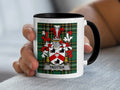 White mug with black handle featuring the Trotter family crest on a tartan background.