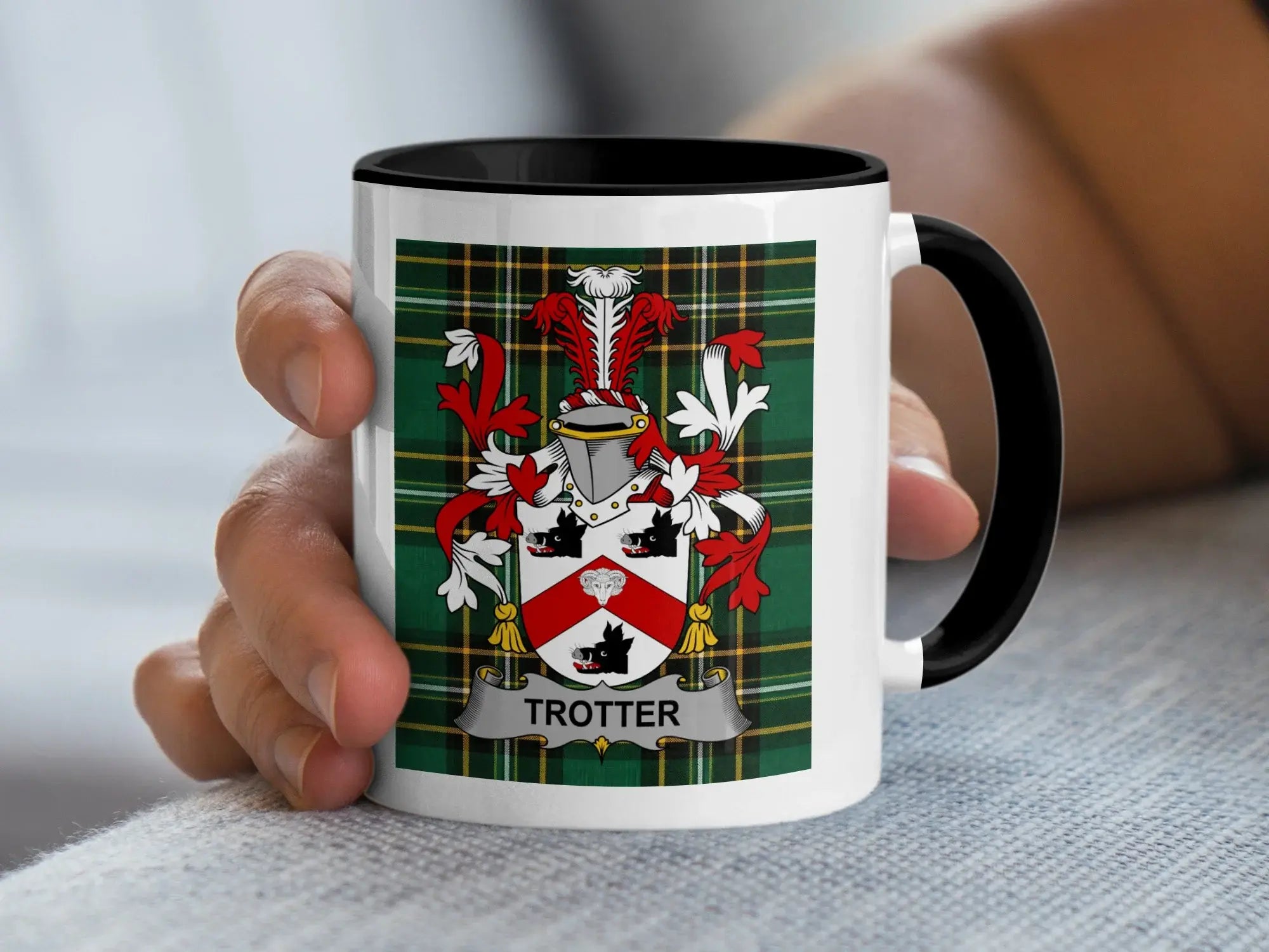 White mug with black handle featuring the Trotter family crest on a tartan background.