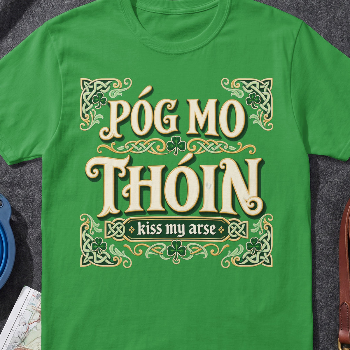 Póg Mo Thóin funny Irish T-shirt in Irish Green, flat-lay mockup