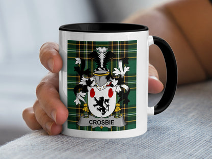 White mug with black handle featuring the Crosbie family crest on a tartan background.