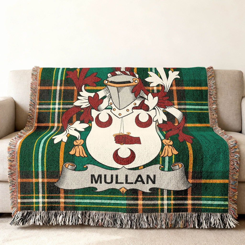 Tartan blanket with Mullan family crest displayed on a couch.
