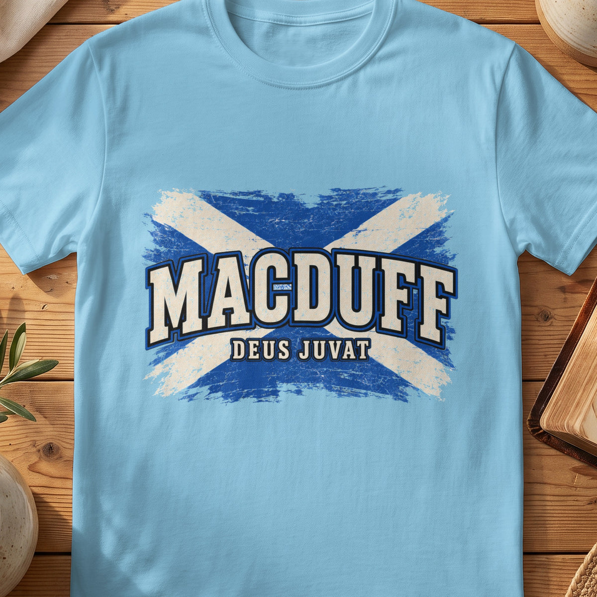 MacDuff Scottish Saltire T-shirt in Sky, with distressed blue and cream flag and “Deus Juvat” lettering.