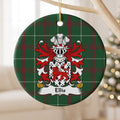 Ellis ornament hanging from a pale wooden branch; a red walking lion on a white shield patterned with black ermine marks on Welsh national tartan.
