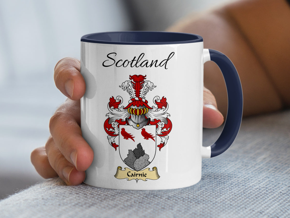 White Cairnie heritage mug with navy handle and interior, displaying “Scotland” and the colourful family emblem.