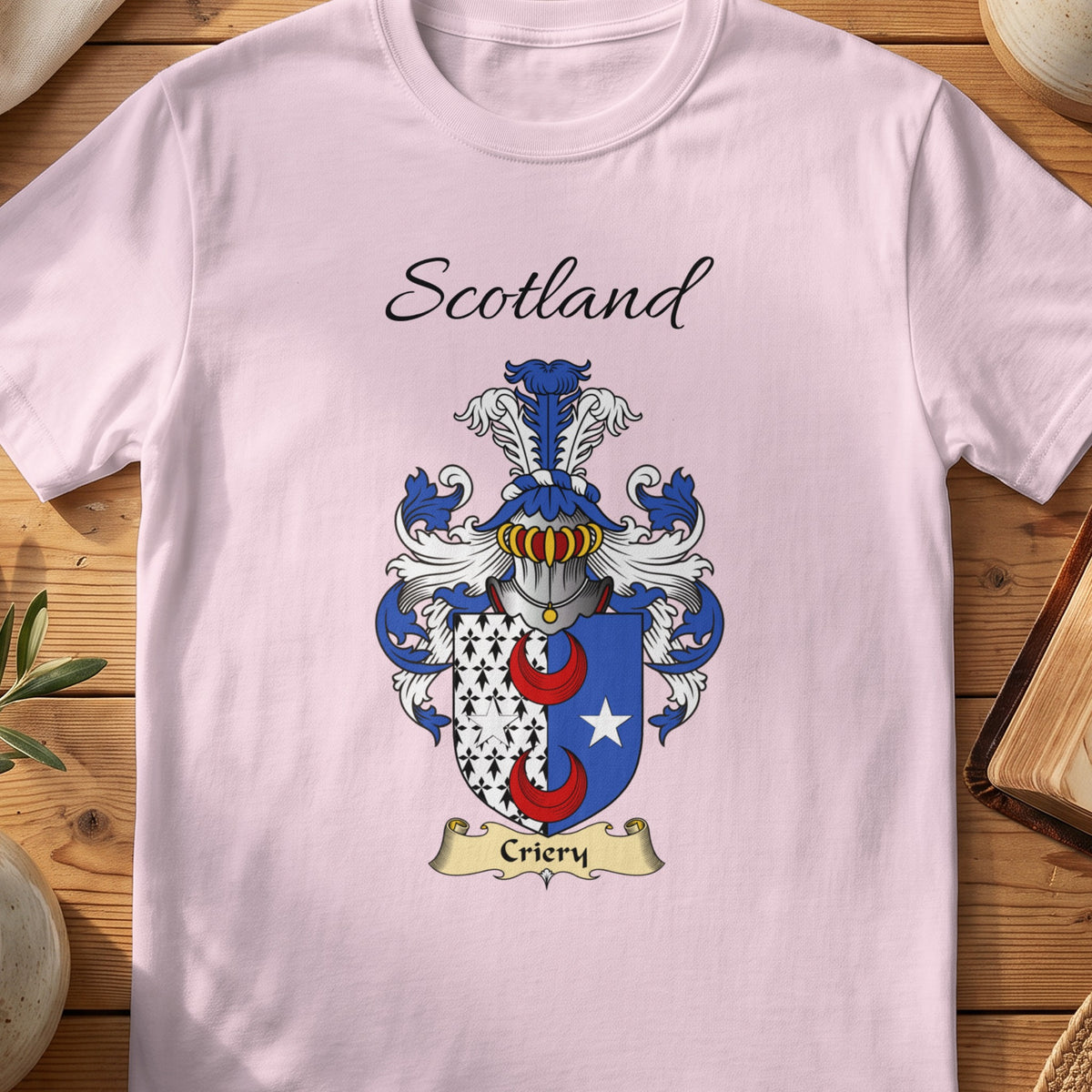 Light Pink Criery Scottish family shield T-shirt featuring red crescents beside a white patterned panel