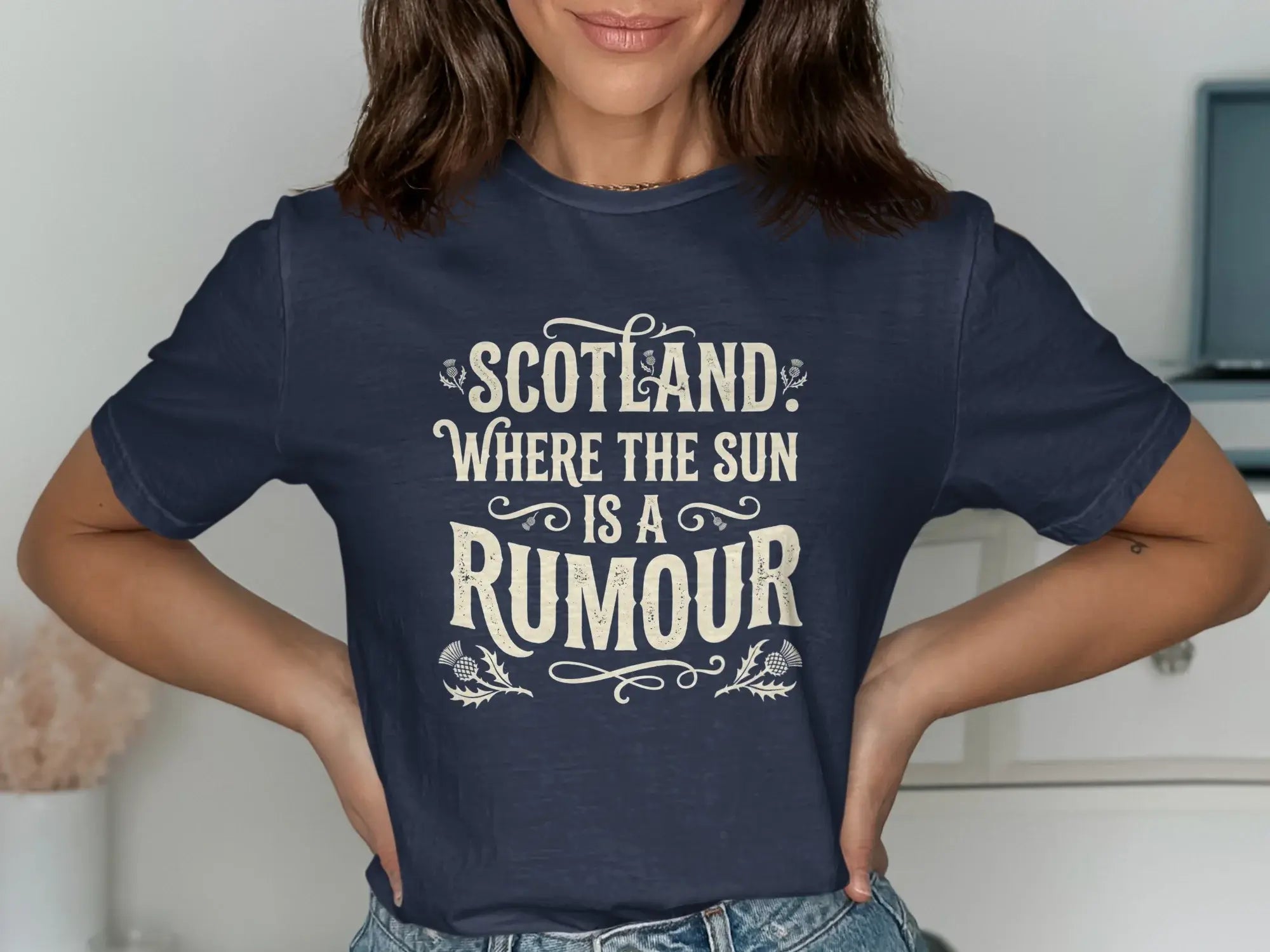 Navy t-shirt with "Scotland: Where the Sun is a Rumour" text and thistle design.