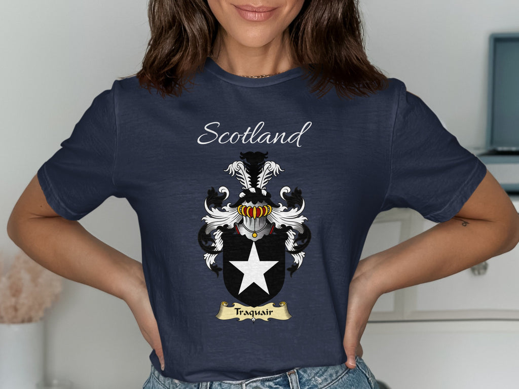 Model wearing the navy Traquair family crest T-shirt featuring “Scotland” and the surname banner.