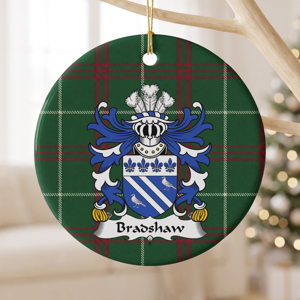 Bradshaw ornament hanging from a pale wooden branch; two white diagonal bands and two white birds on blue beneath four blue fleurs-de-lis on Welsh national tartan.