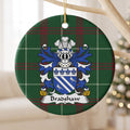 Bradshaw ornament hanging from a pale wooden branch; two white diagonal bands and two white birds on blue beneath four blue fleurs-de-lis on Welsh national tartan.