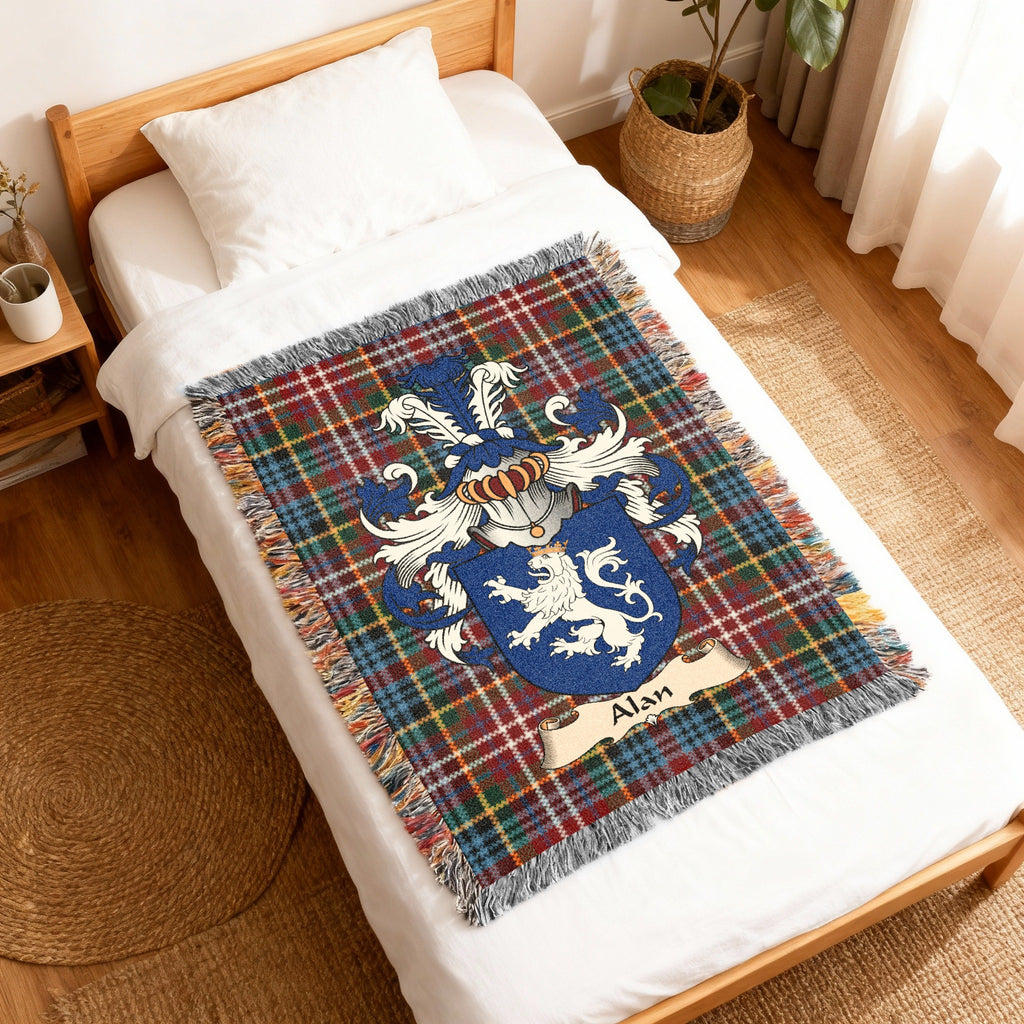 Alan Scottish family shield woven blanket with Caledonia tartan background, displayed on a bed