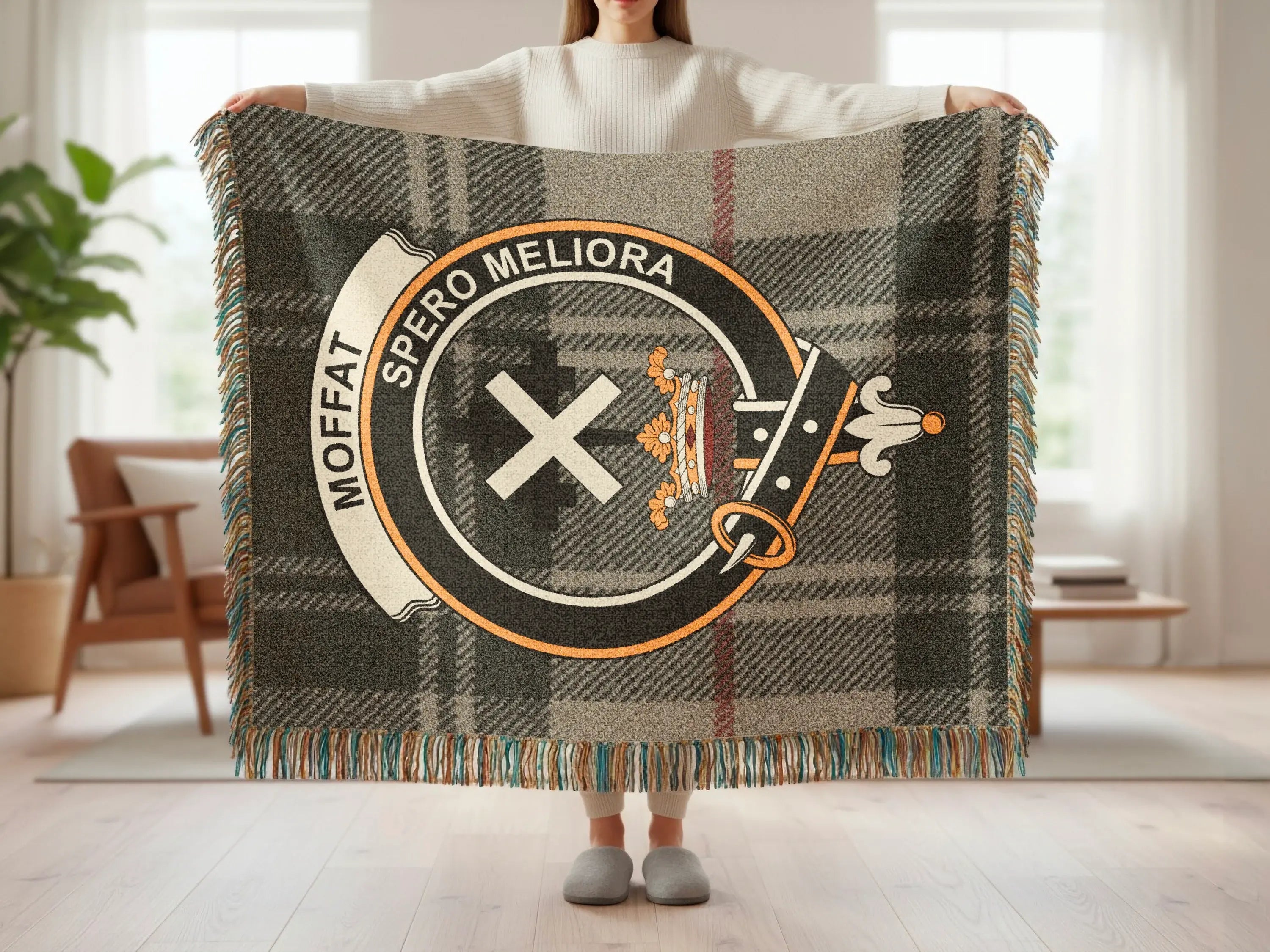 Moffat tartan woven blanket showing clan crest detail — cotton construction with colourful fringe border