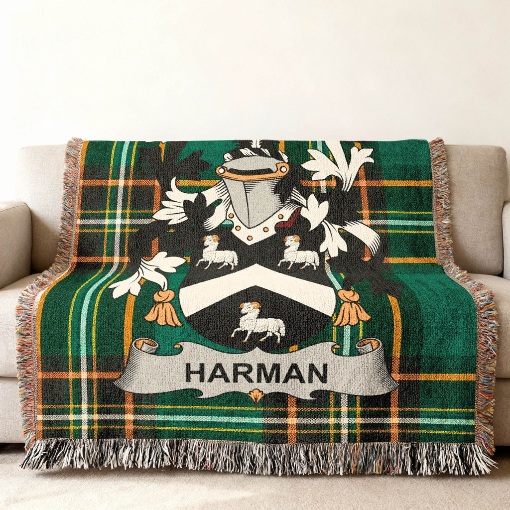Green and black plaid throw blanket with HARMAN coat of arms.