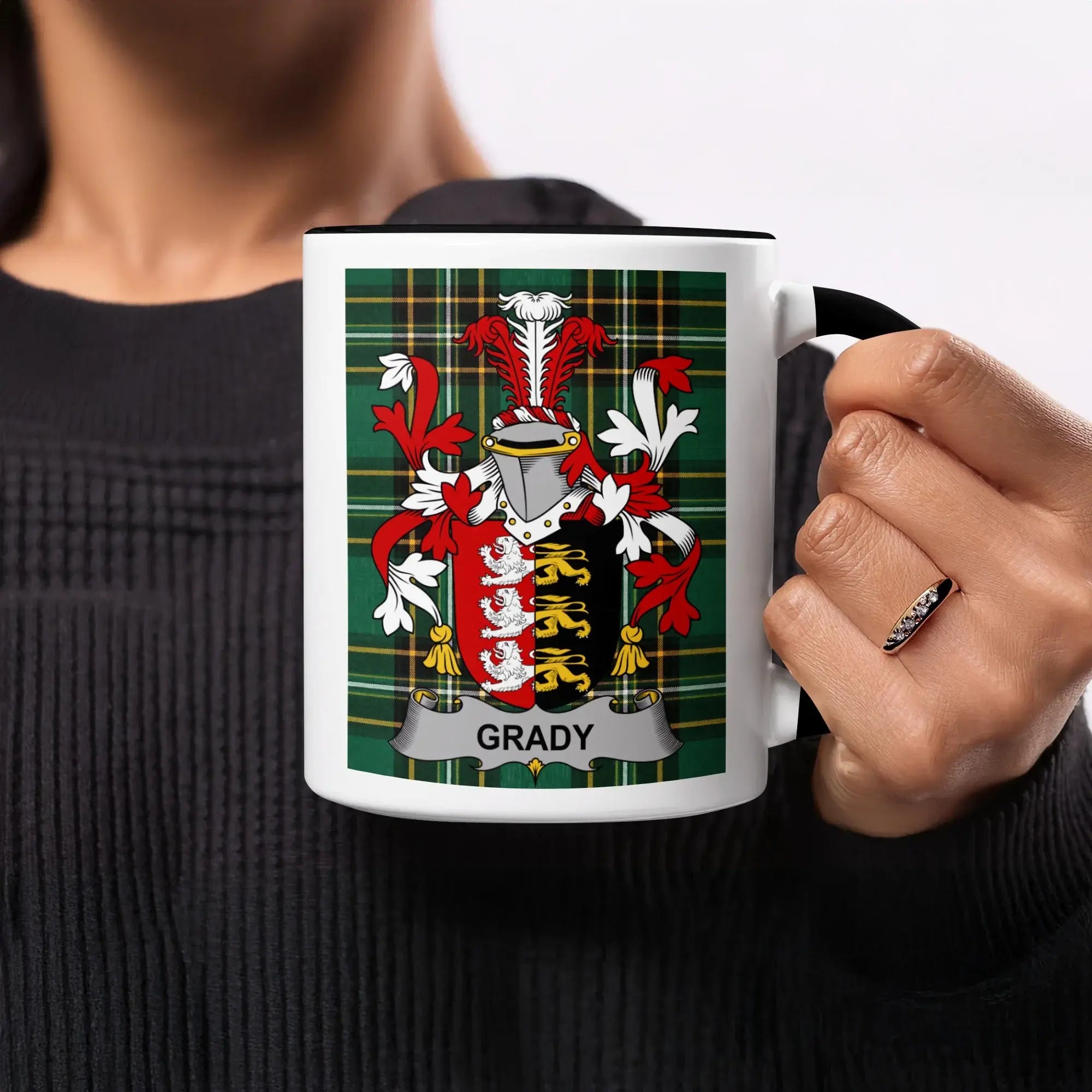 Black mug with Grady family crest on a tartan background.