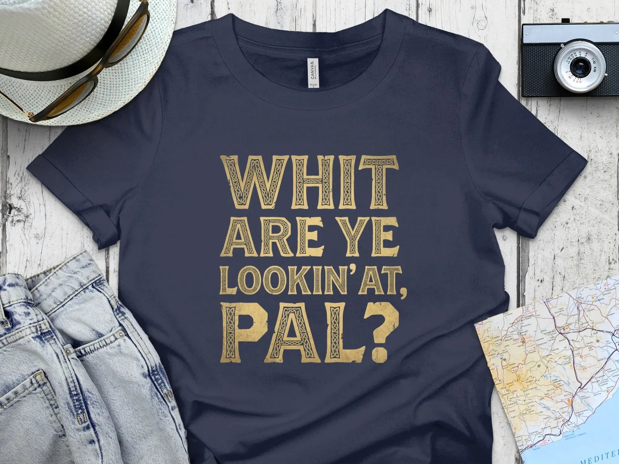 Navy t-shirt with gold text "WHIT ARE YE LOOKIN'AT, PAL?".