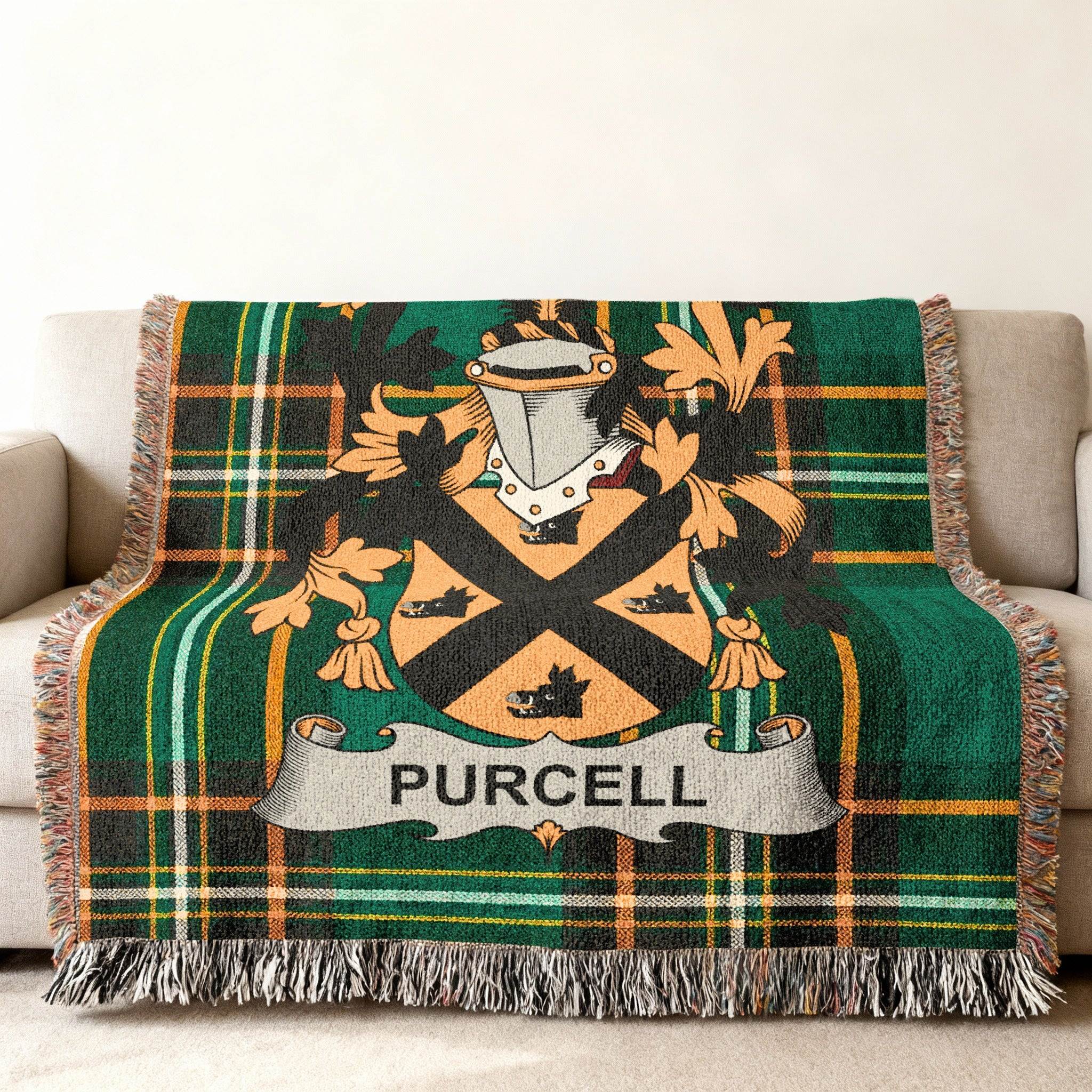 Green tartan blanket with Purcell family crest draped over a sofa.
