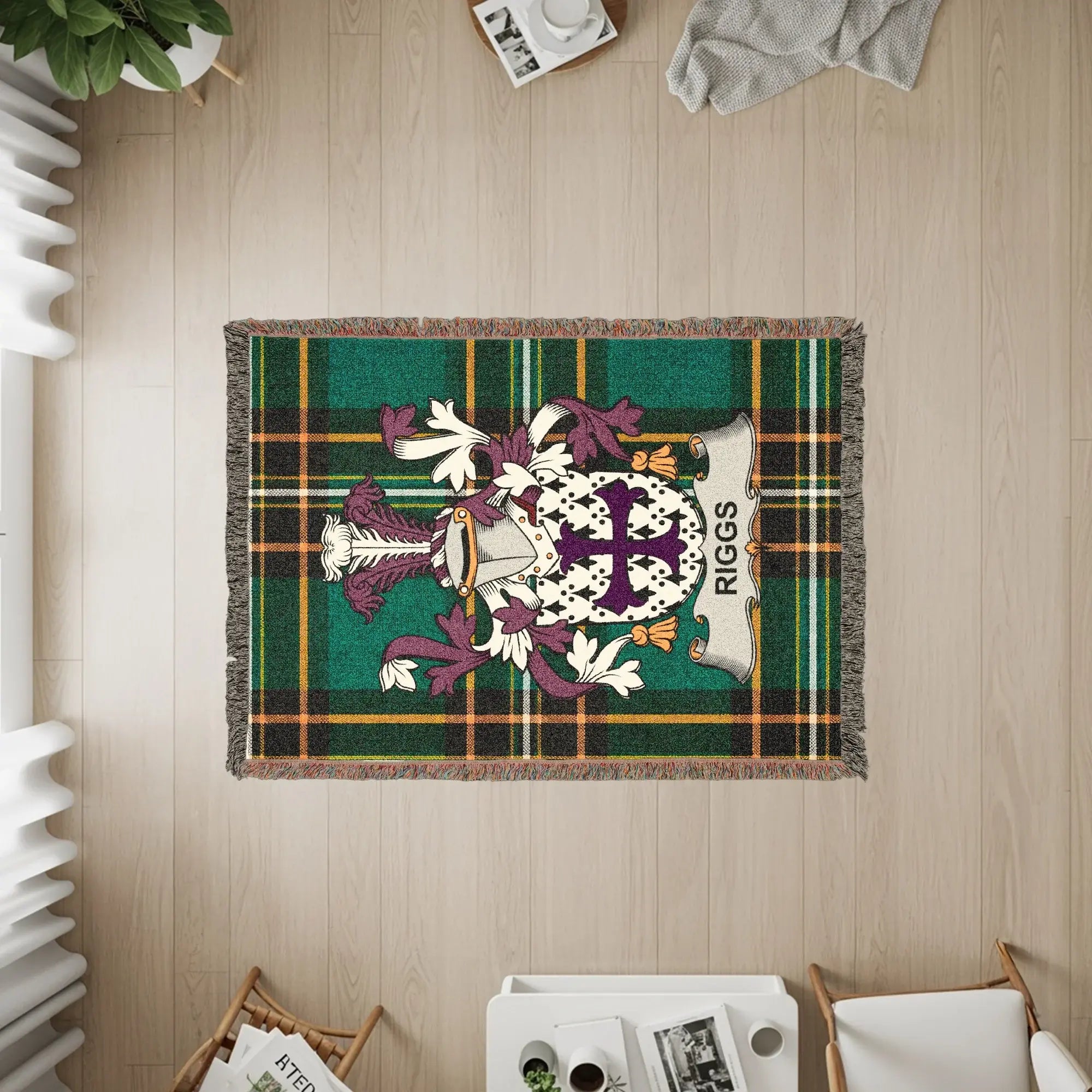 Green plaid woven blanket with Riggs family crest.