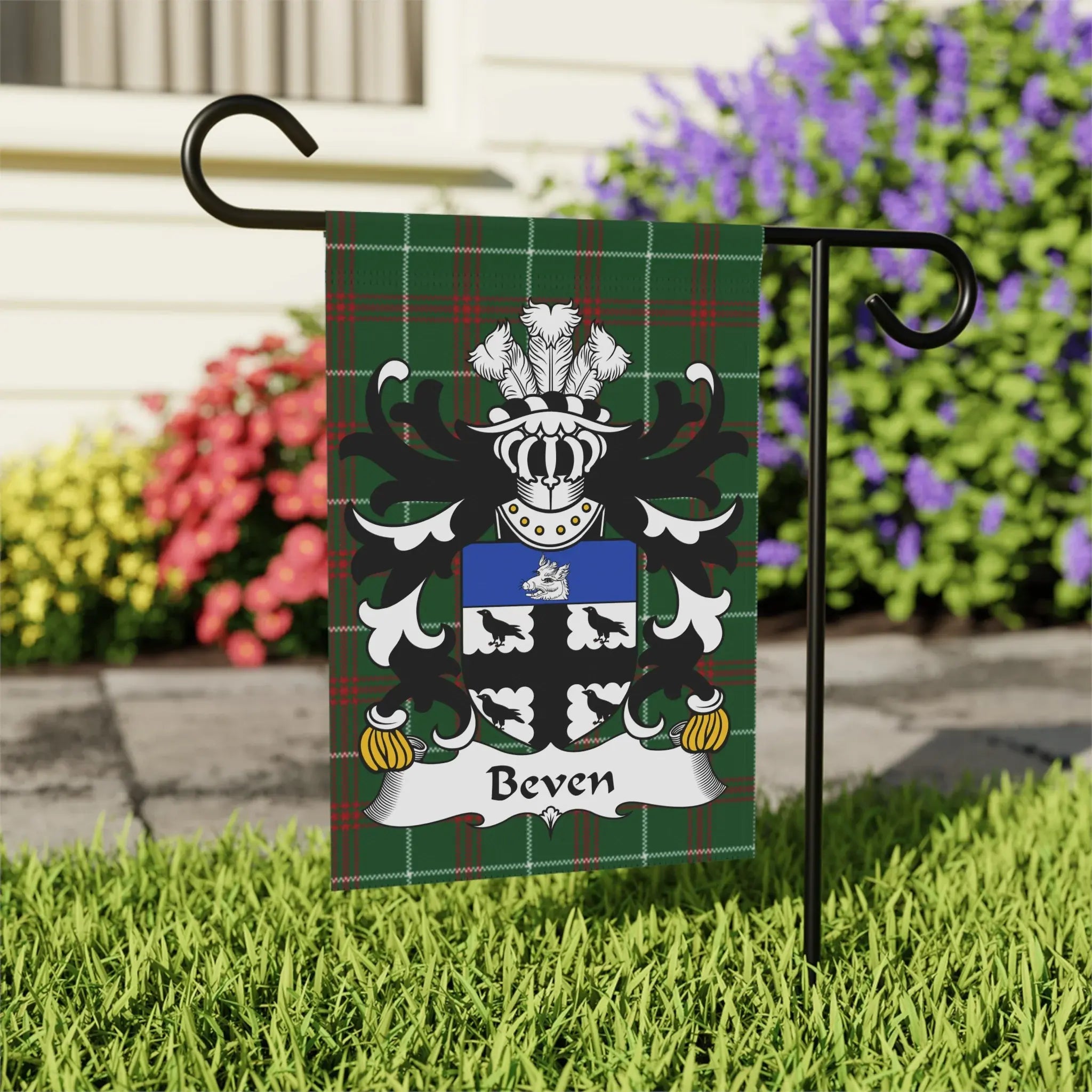 Beven family crest on a green plaid garden flag.
